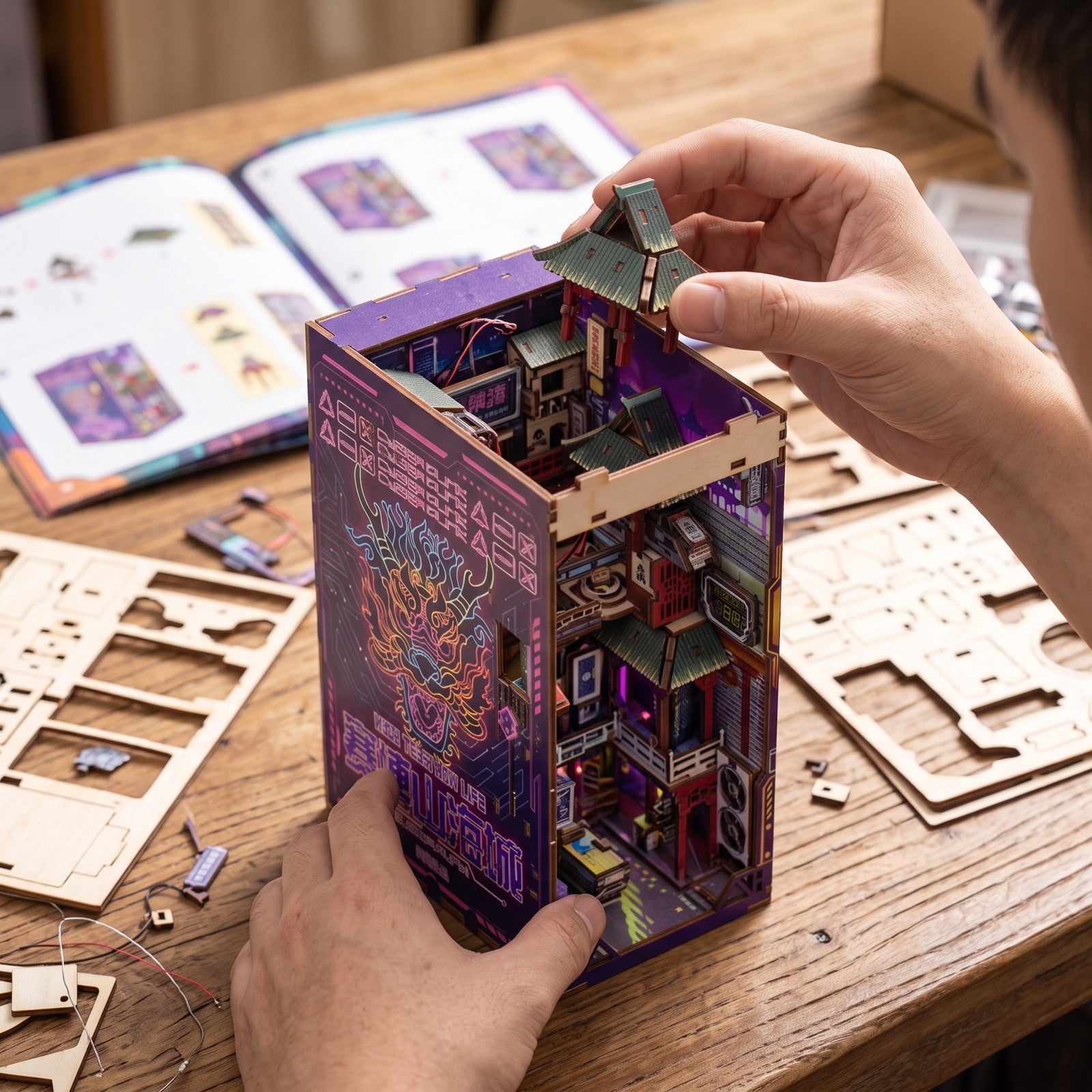Adult hands carefully assembling the book nook