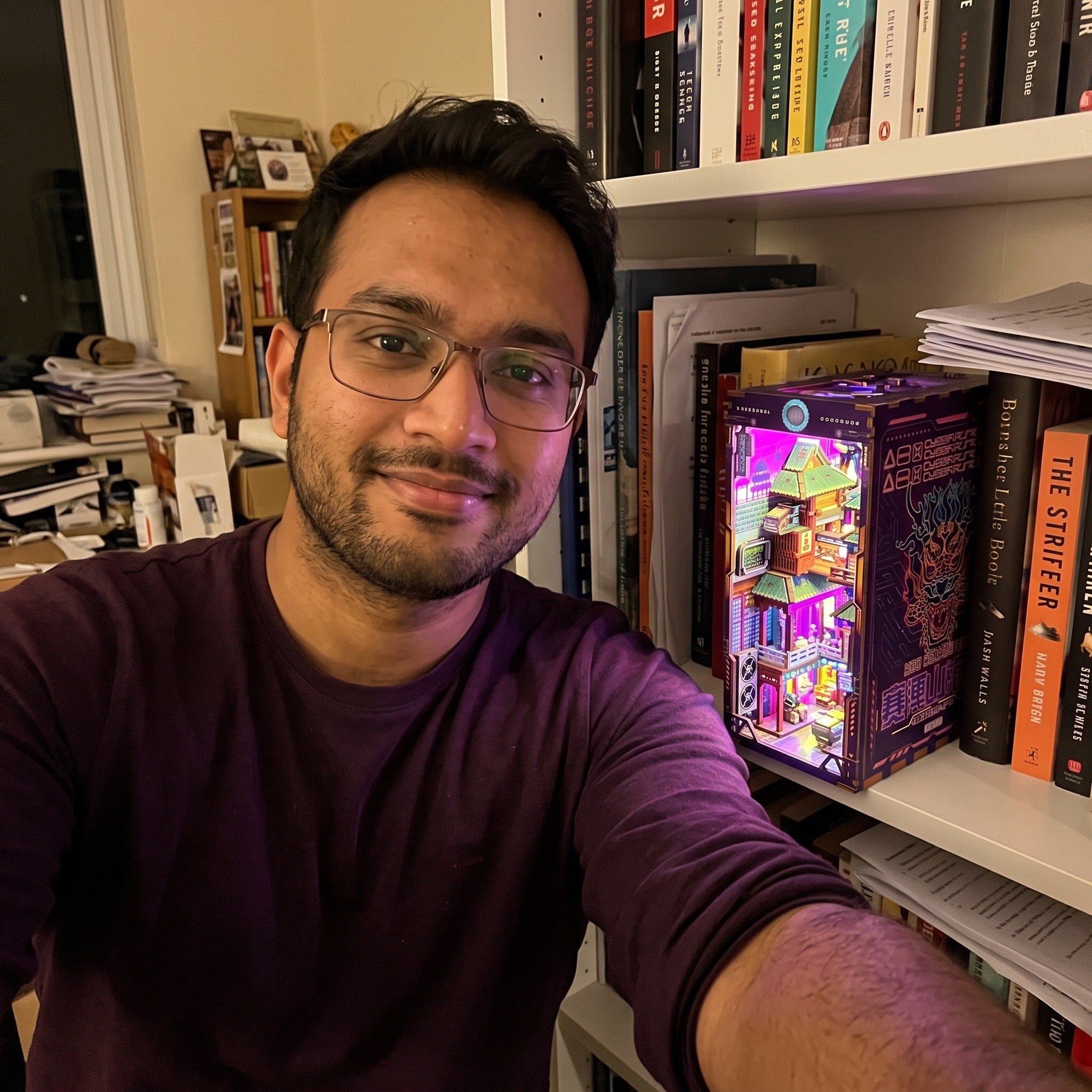 Man taking a selfie beside his study book nook