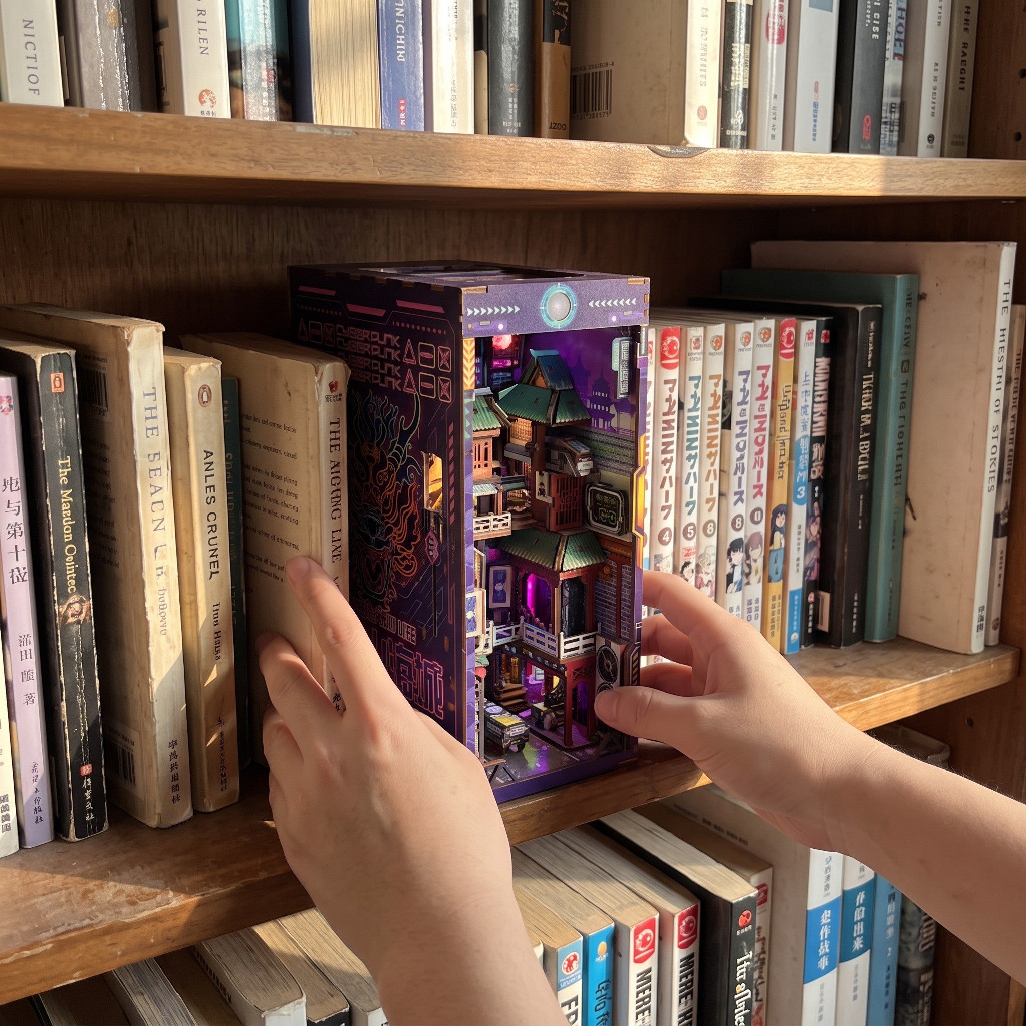 Hands placing the finished model between books